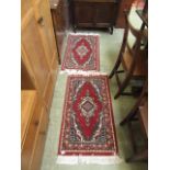 Two small rectangular red ground rugs