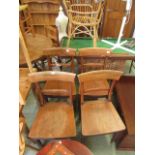 A set of four rail back dining chairs