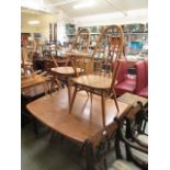 A light Ercol drop-leaf table together w