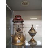 An early 20th century paraffin lamp toge