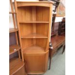 A light Ercol full height corner cabinet