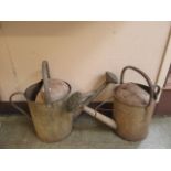 Two galvanized watering cans