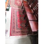 A rectangular red ground rug