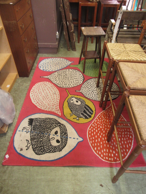 A modern pink rug with animal decoration