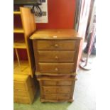 A pair of stained pine three drawer beds