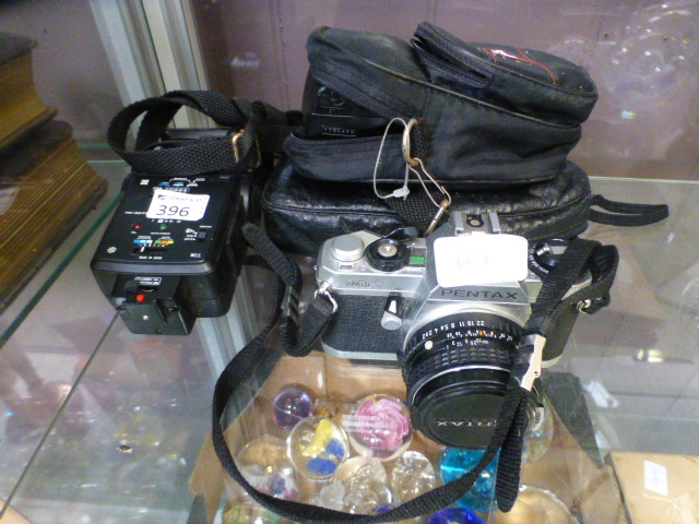 A Pentax MG camera together with an asso