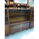 A mid-20th century bookcase with sliding