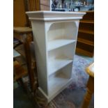 A white painted open bookcase