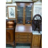 A reproduction mahogany bureau bookcase