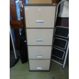 A four drawer filing cabinet with key