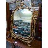 A modern gilt metal toilet mirror