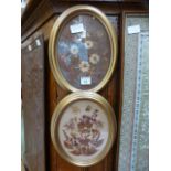 A pair of oval framed artworks of dried