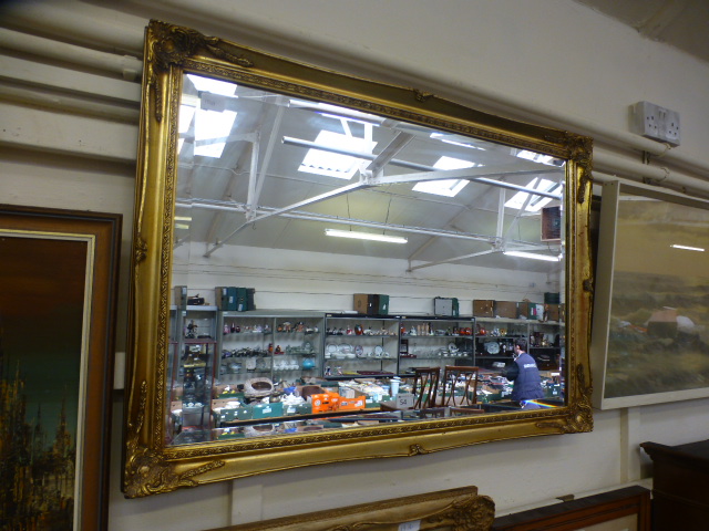 A gilt framed rectangular mirror