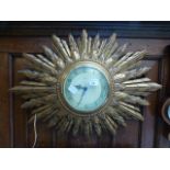 A Smith's electric sunburst wall clock