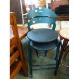 A pair of green metal stacking stools