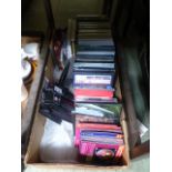 A small box containing DVDs and CDs