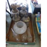 A tray containing four oil lamps and ass