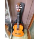 An Admira acoustic guitar with bag