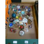 A tray of assorted glass paperweights