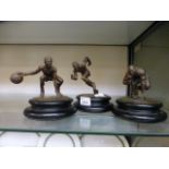 Three bronze sporting figures signed War