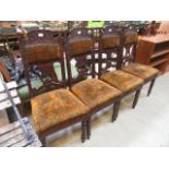 A set of four Edwardian carved back dini