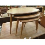 A nest of three light Ercol pebble table