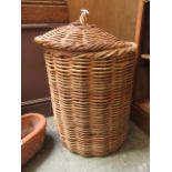 A wicker lidded linen baslet