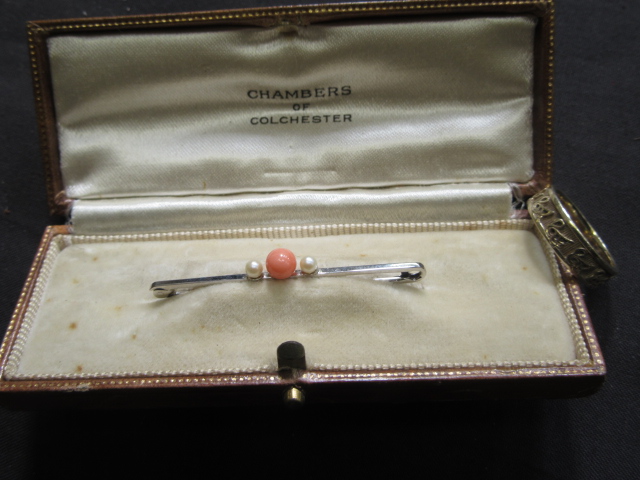 A boxed white metal, coral and seed pear