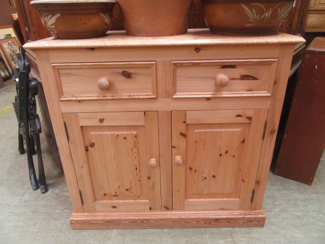 A waxed pine dresser base having two dra