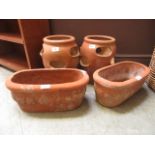 A pair of garden strawberry pots togethe