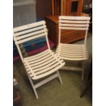 A pair of white PVC folding garden chair