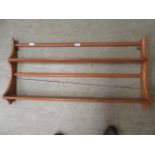 A light Ercol wall mounted shelf unit