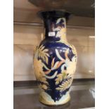 A large ceramic baluster vase having flo