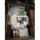 A tray containing postcards, magazines,