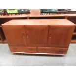 A light Ercol Windsor sideboard having t