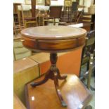 A reproduction mahogany drum table