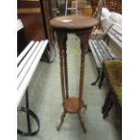 A distressed mahogany jardiniere stand w