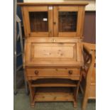 A waxed pine bookcase having a pair of g