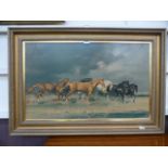 A gilt framed print of running horses