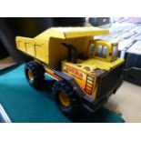 A yellow Tonka toy dumper truck