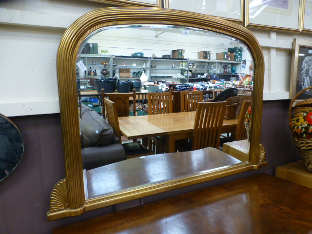A reproduction gilt over mantle mirror,