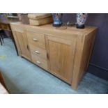 A modern oak sideboard, the top over two