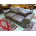 A modern brown leather three seater Ches