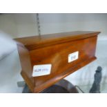 A mahogany box with lift up lid conceali
