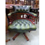 A reproduction green leather upholstered