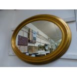 An oval gilt framed mirror