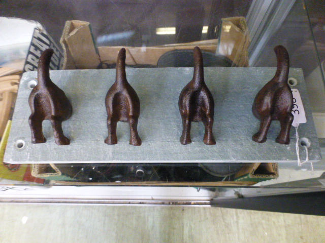 Four dog tail hooks on slate back