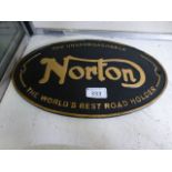 A black and gold Norton sign