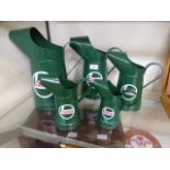 Five Castrol oil cans