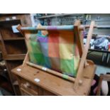 A folding fabric and pine magazine rack